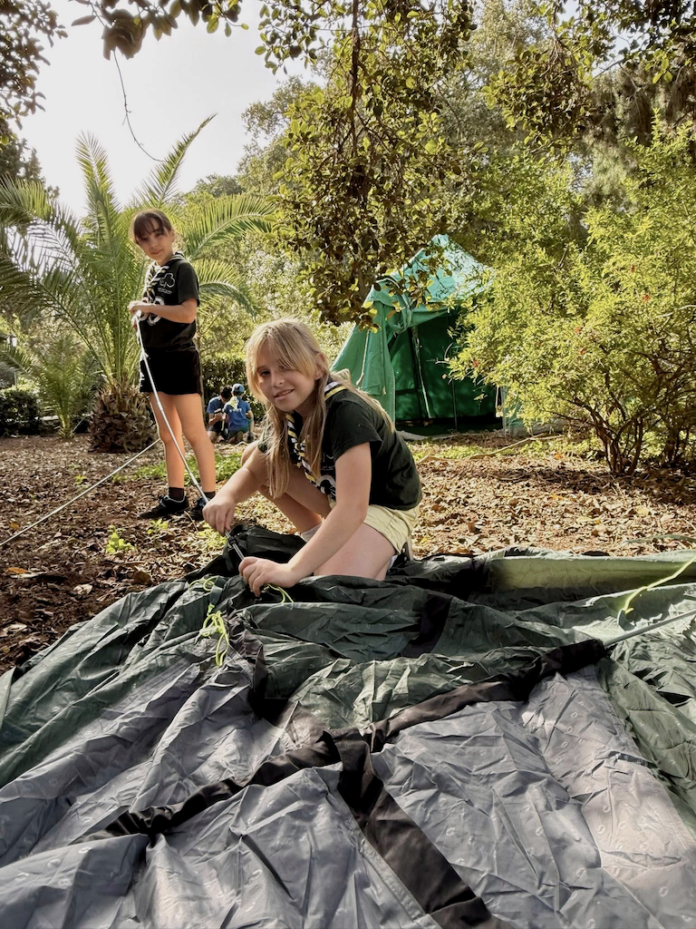 Girl Guides pitching a tent during camp
